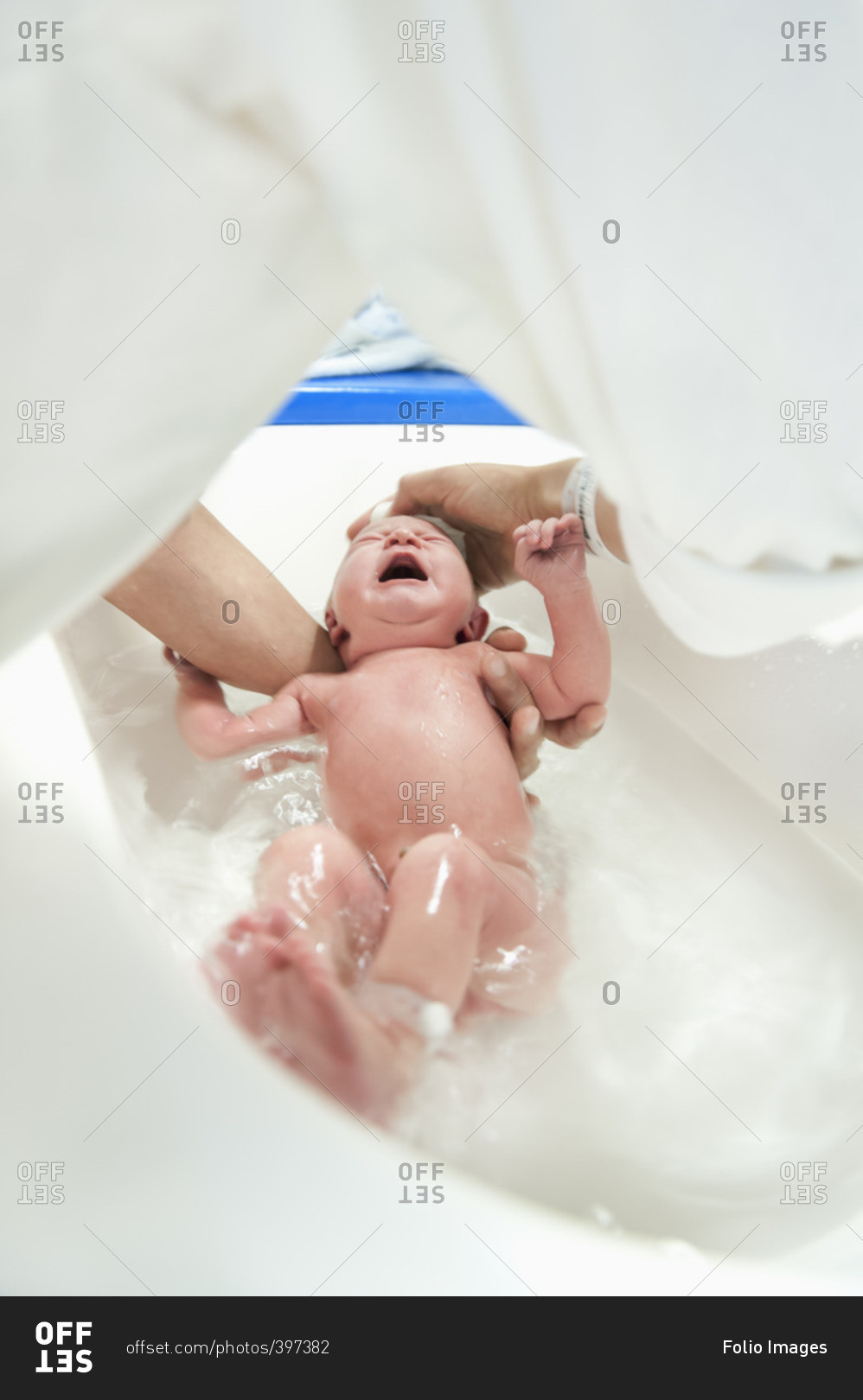Sweden, Woman bathing newborn baby girl (0-1 months)