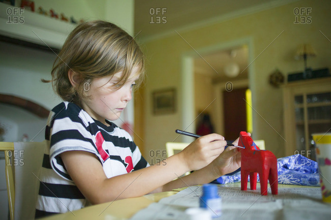 Sweden, Narke, Filipshyttan, Boy painting horses