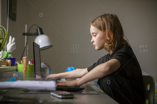Sweden, Vastergotland, Lerum, Boy using laptop at desk
