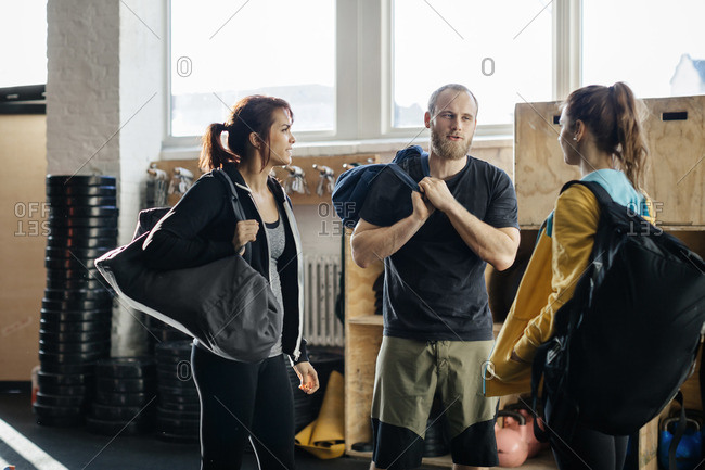 Germany, Young women and man with gym bags in gym
