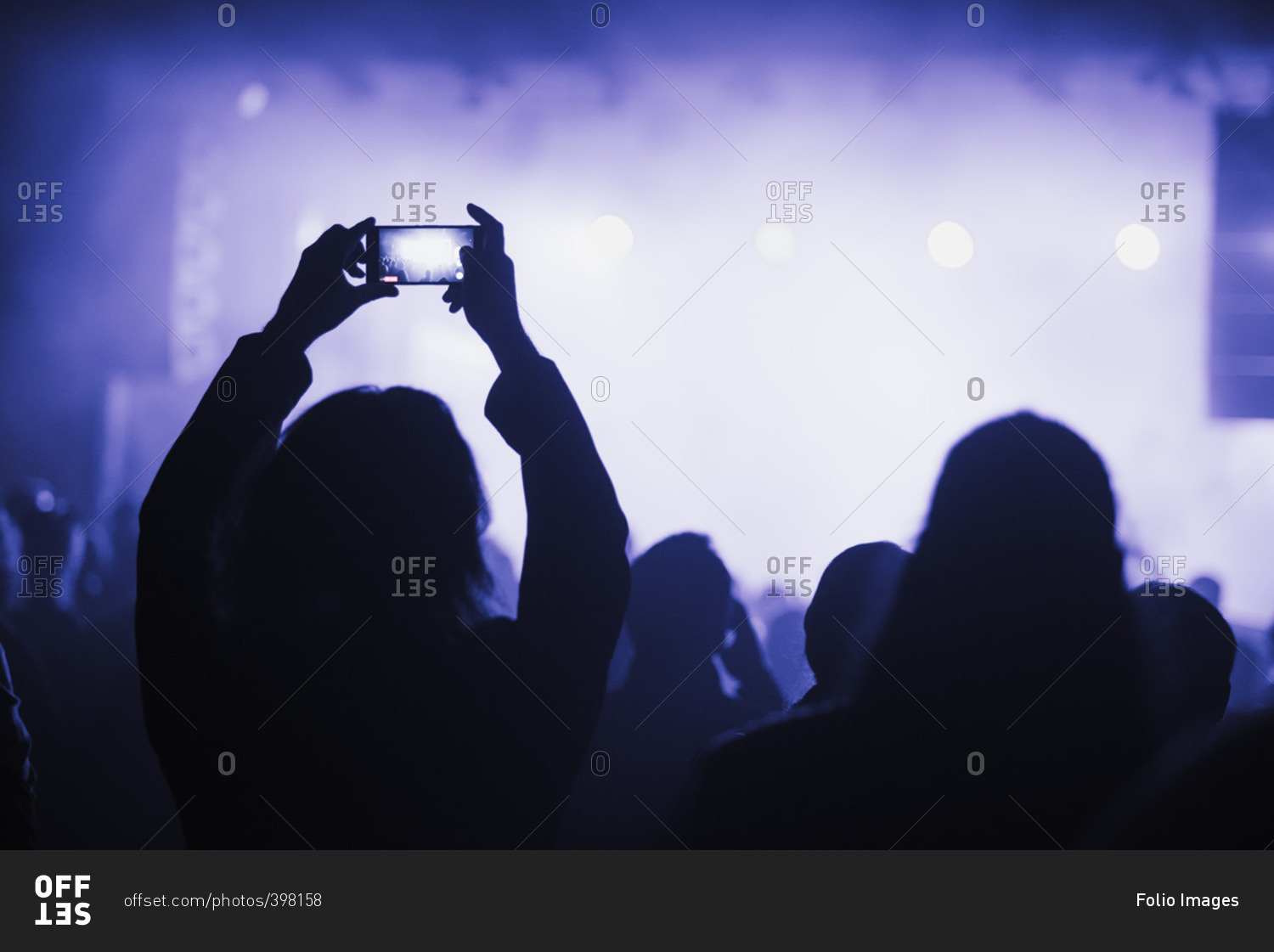 Finland, Uusimaa, Helsinki, Woman using smart phone on concert