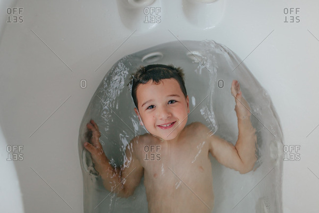 Boy Lying Down In A Bathtub Stock Photo, How To Lay Down In A Bathtub