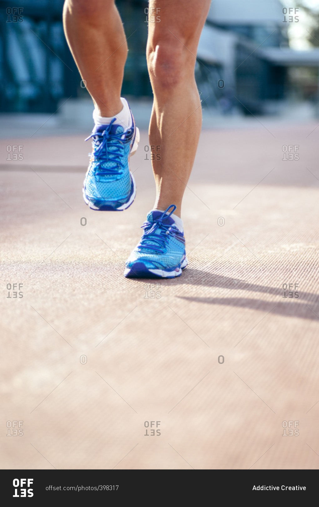 Athletic woman's feet on a race track