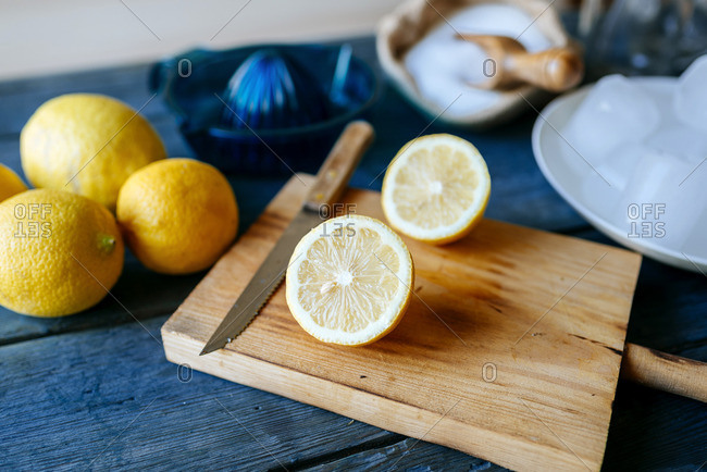 Ingredients to make lemonade- chopped lemon on chopping board