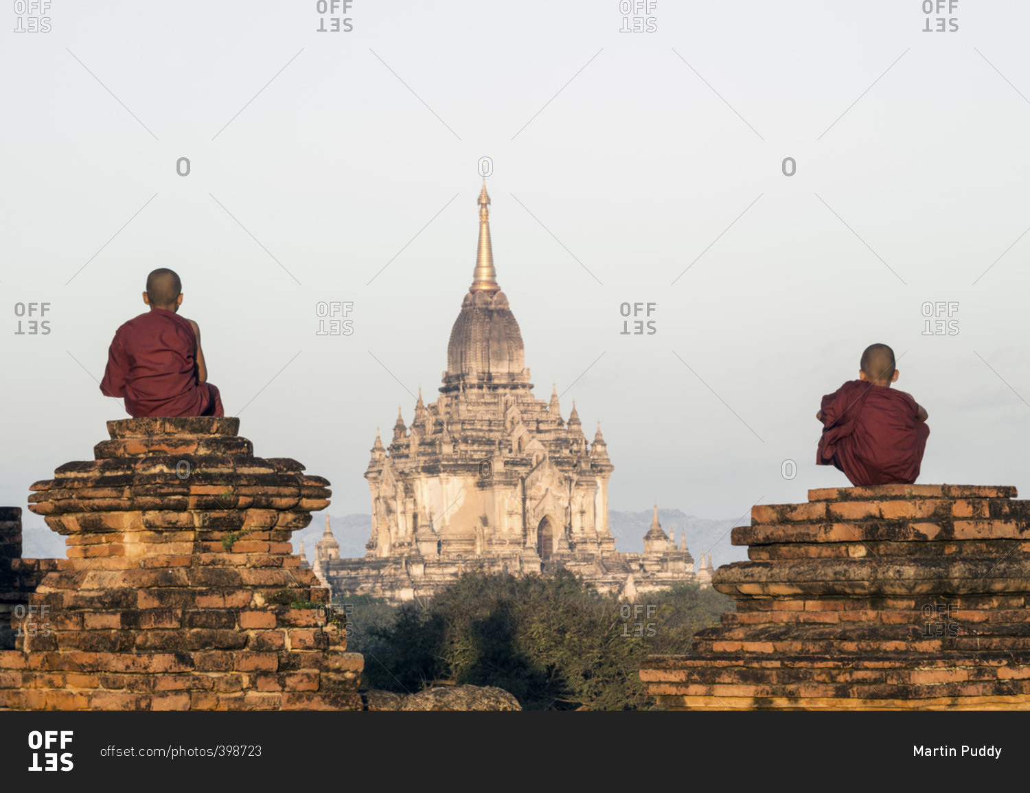 Two young Buddhist monks overlooking ancient temples in Bagan, Myanmar