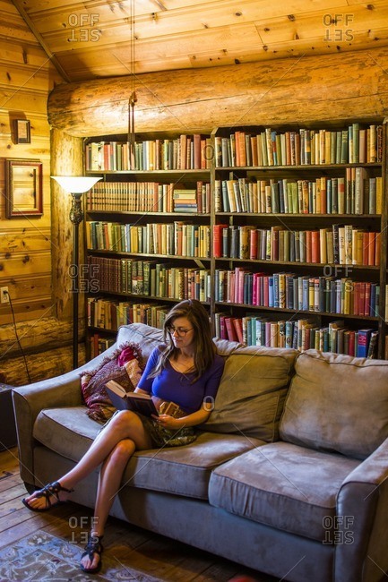 Snohomish, WA - July 29, 2015: A woman reads a book on a couch in a bookstore in Snohomish, WA