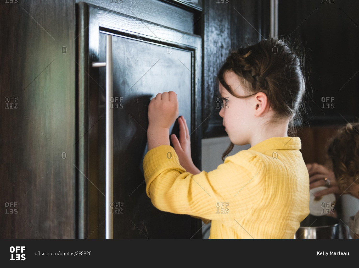 Young girl knocking on door