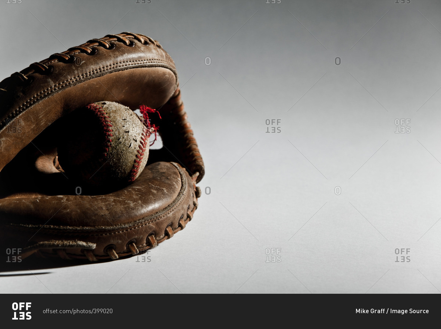 Close up of a baseball ball in a glove