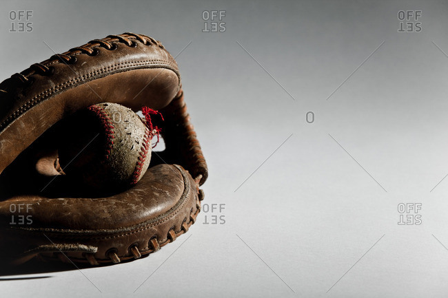 Close up of a baseball ball in a glove