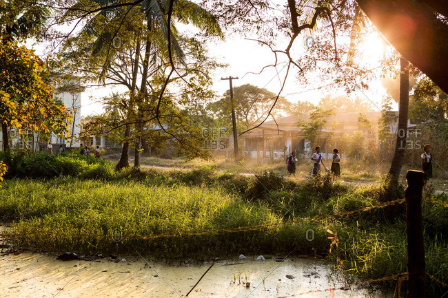 Dala township, Myanmar - December 30 2014: Burmese children walk home from school