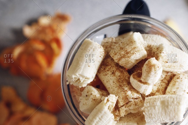 Overhead view of bananas in blender on table