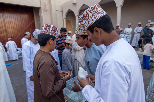 NIZWA, OMAN - APRIL 24 2015:Omani children at the traditional bird market or souq in Nizwa, Oman.