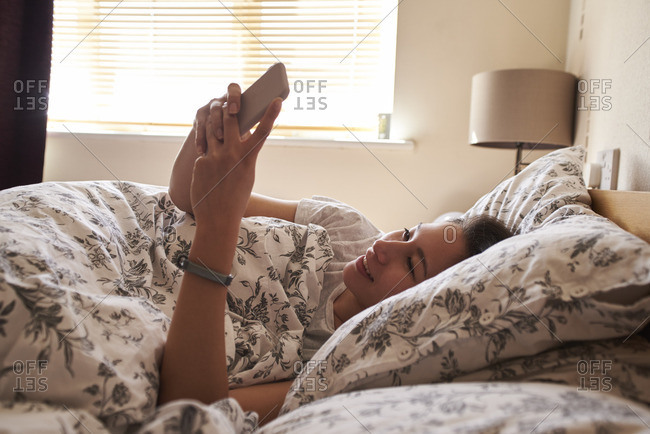 woman wake up in bed stock photos - OFFSET