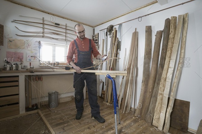 Male bow maker making bow in workshop, Bavaria, Germany