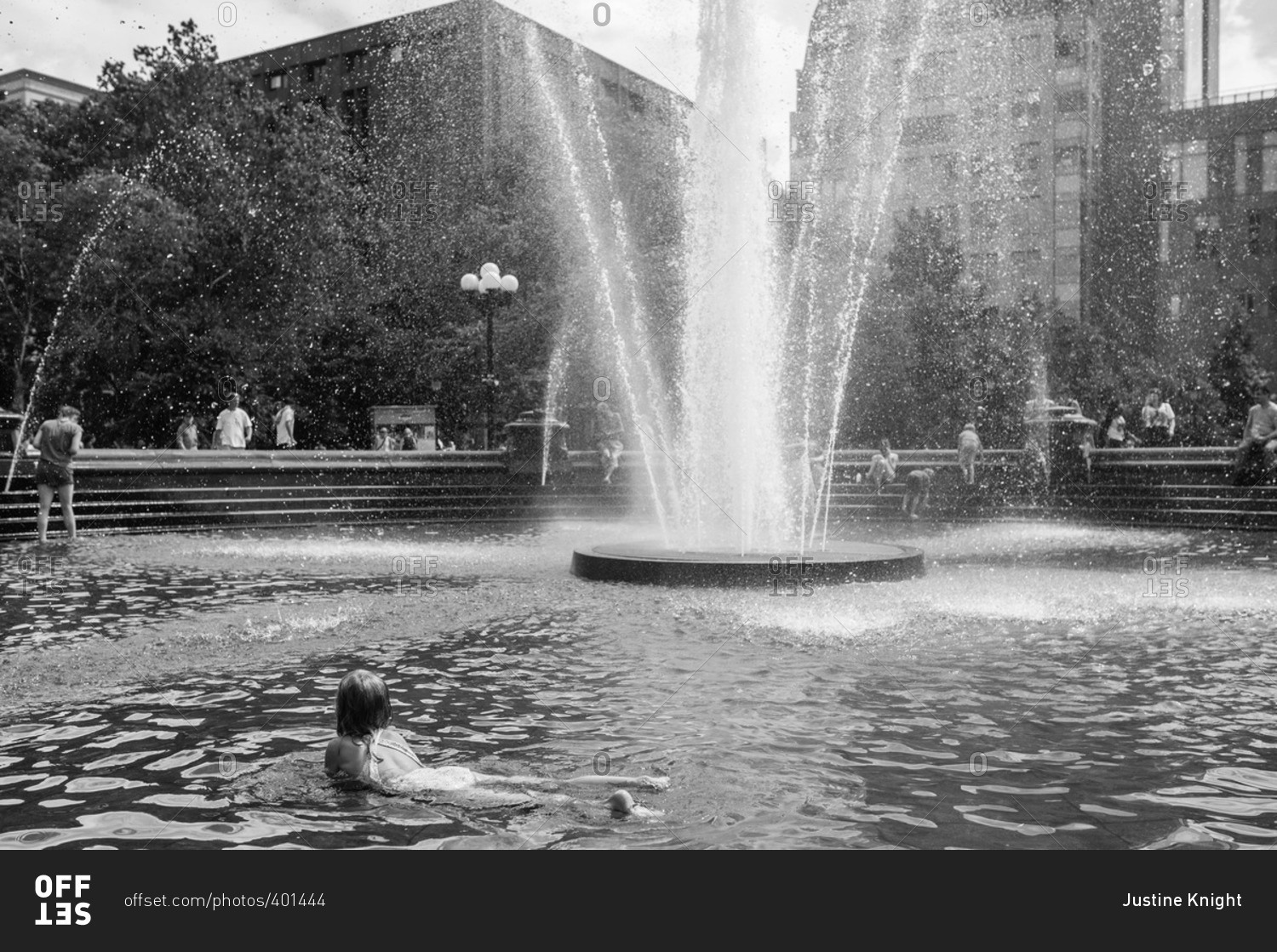 Girl in a city fountain