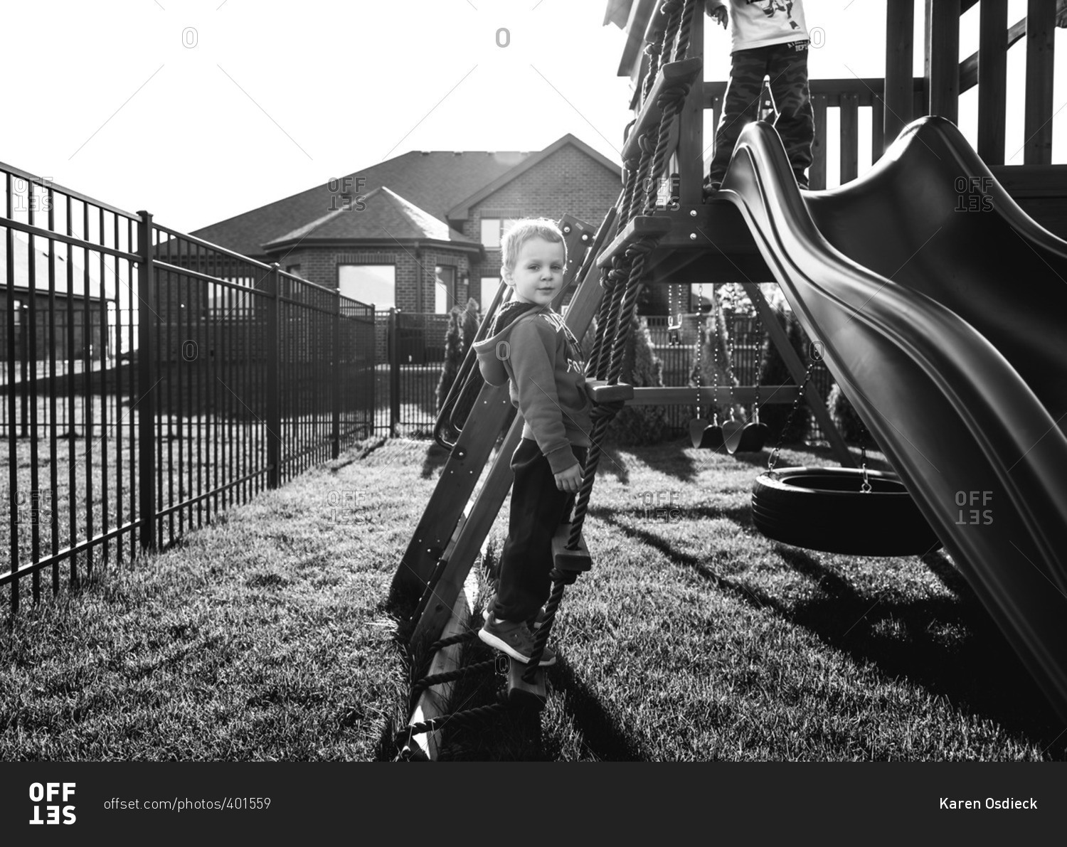 boy-climbing-up-a-ladder-to-his-play-set-stock-photo-offset