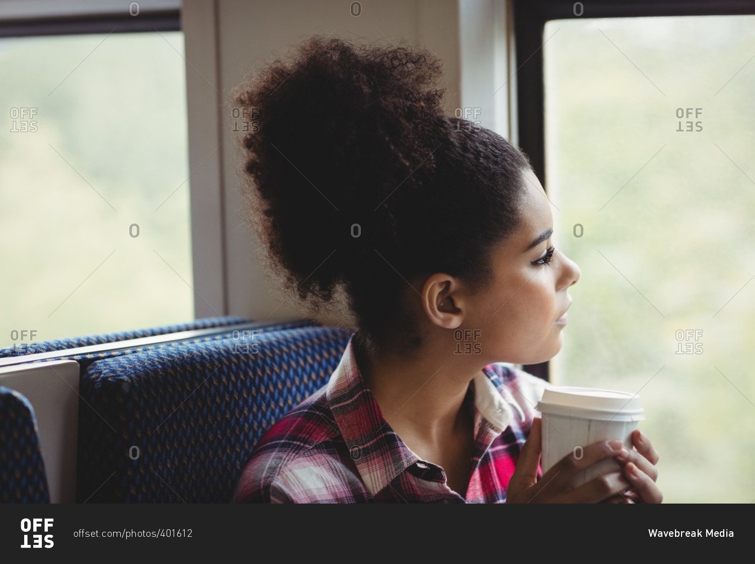 Close-up of thoughtful woman looking through window in train