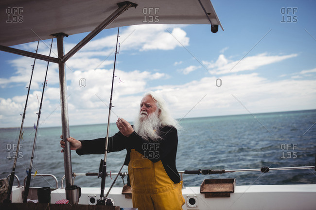 Fisherman adjusting fishing hook