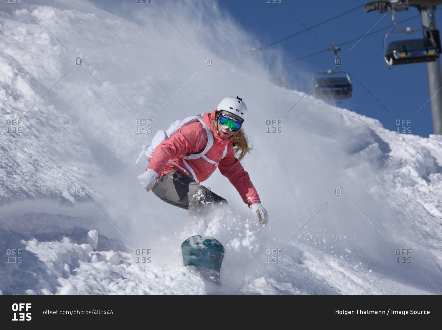 Young woman snowboarding on steep mountain, Hintertux, Tyrol, Austria