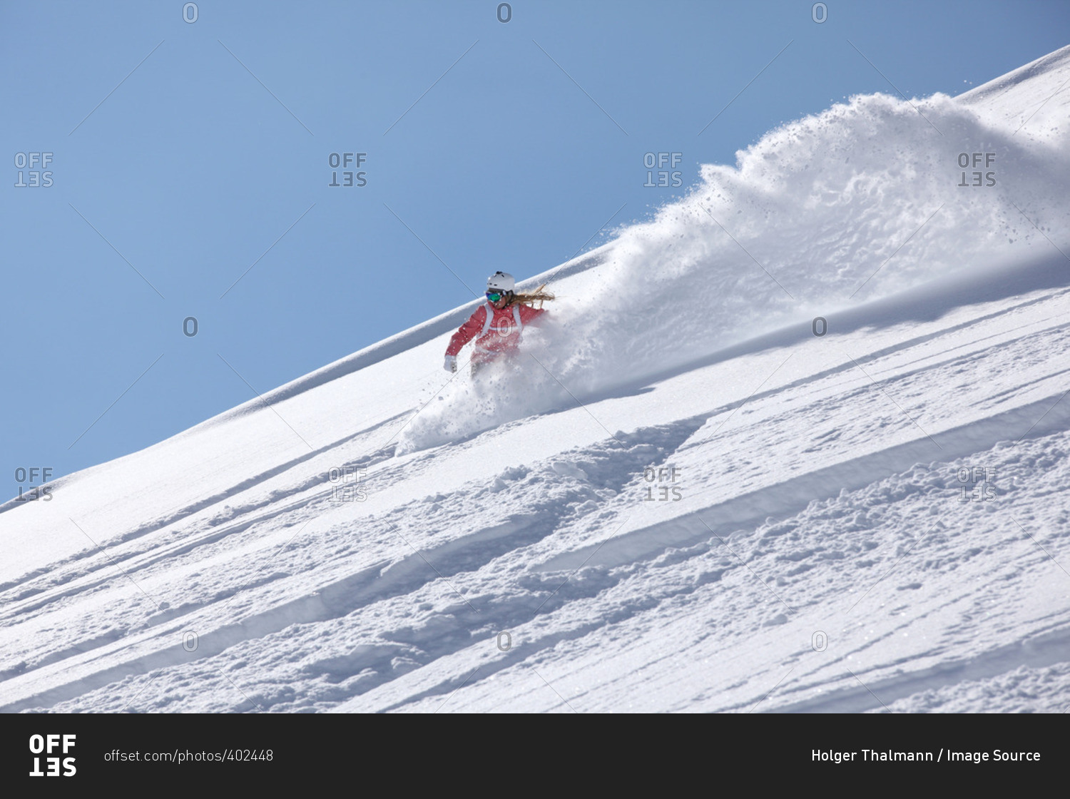 Young woman snowboarding down steep mountain, Hintertux, Tyrol, Austria