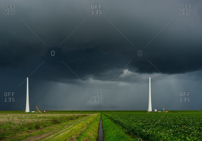 Thunderstorm approaching wind turbines under construction, Netherlands