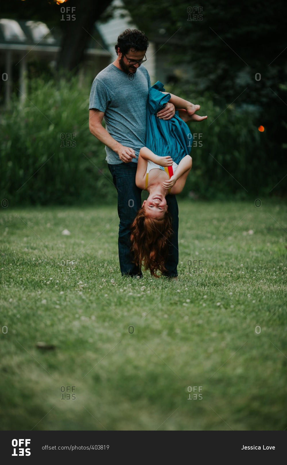 Father holding daughter upside down stock photo OFFSET