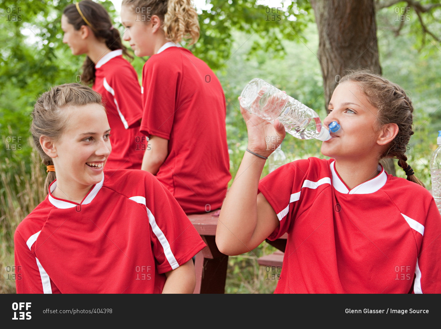 Girl soccer players drinking water