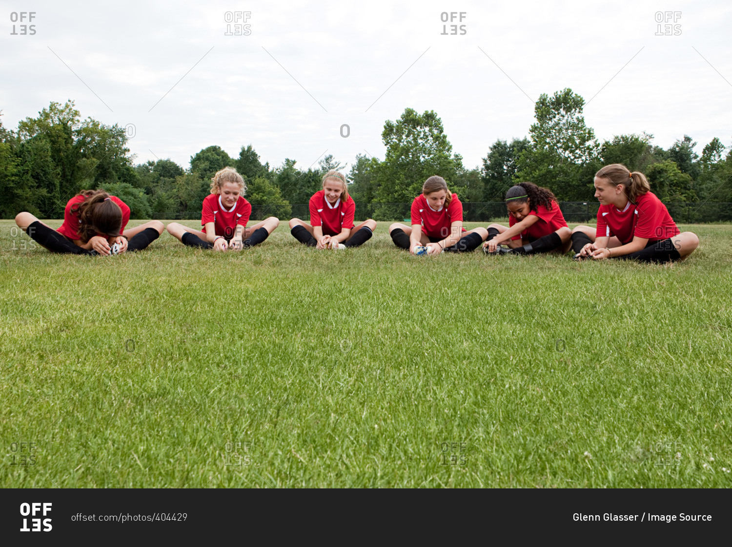 Five girl soccer players on field