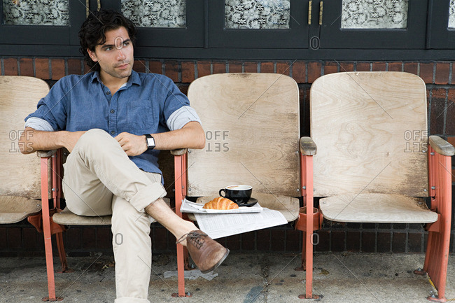 Man sitting outside coffee shop
