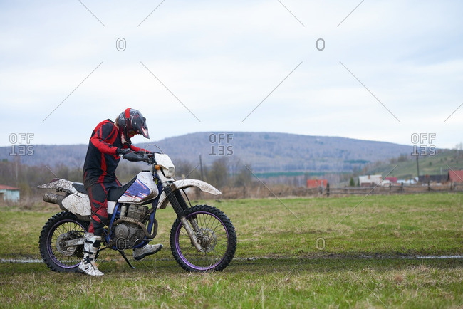 Rider starting his motorcycle in the countryside