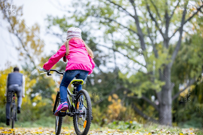Rear view of girl cycling in autumn