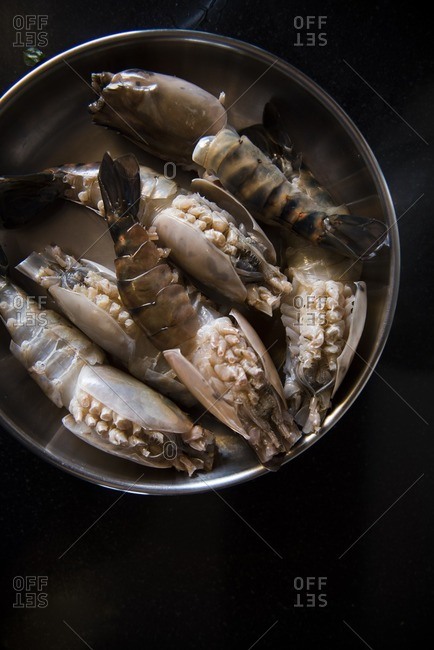 Overhead view of fresh lobster tails in pot