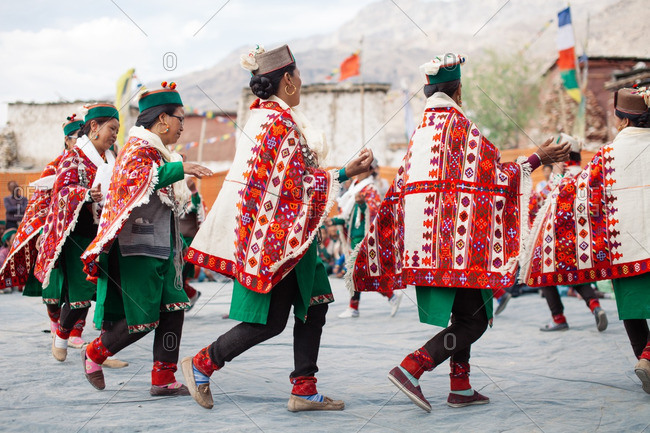 June 27, 2016: Women in traditional green costumes moving in a circle