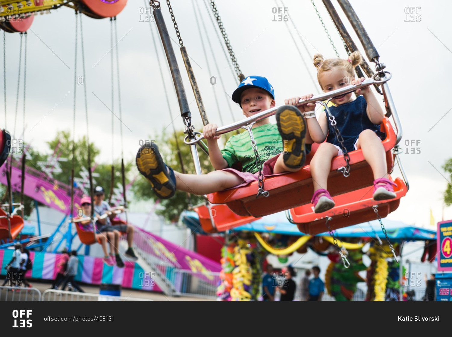 Children riding on a carnival swing