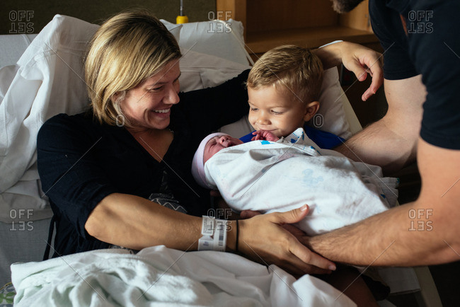 Family spending time together in a maternity ward after the birth of their baby