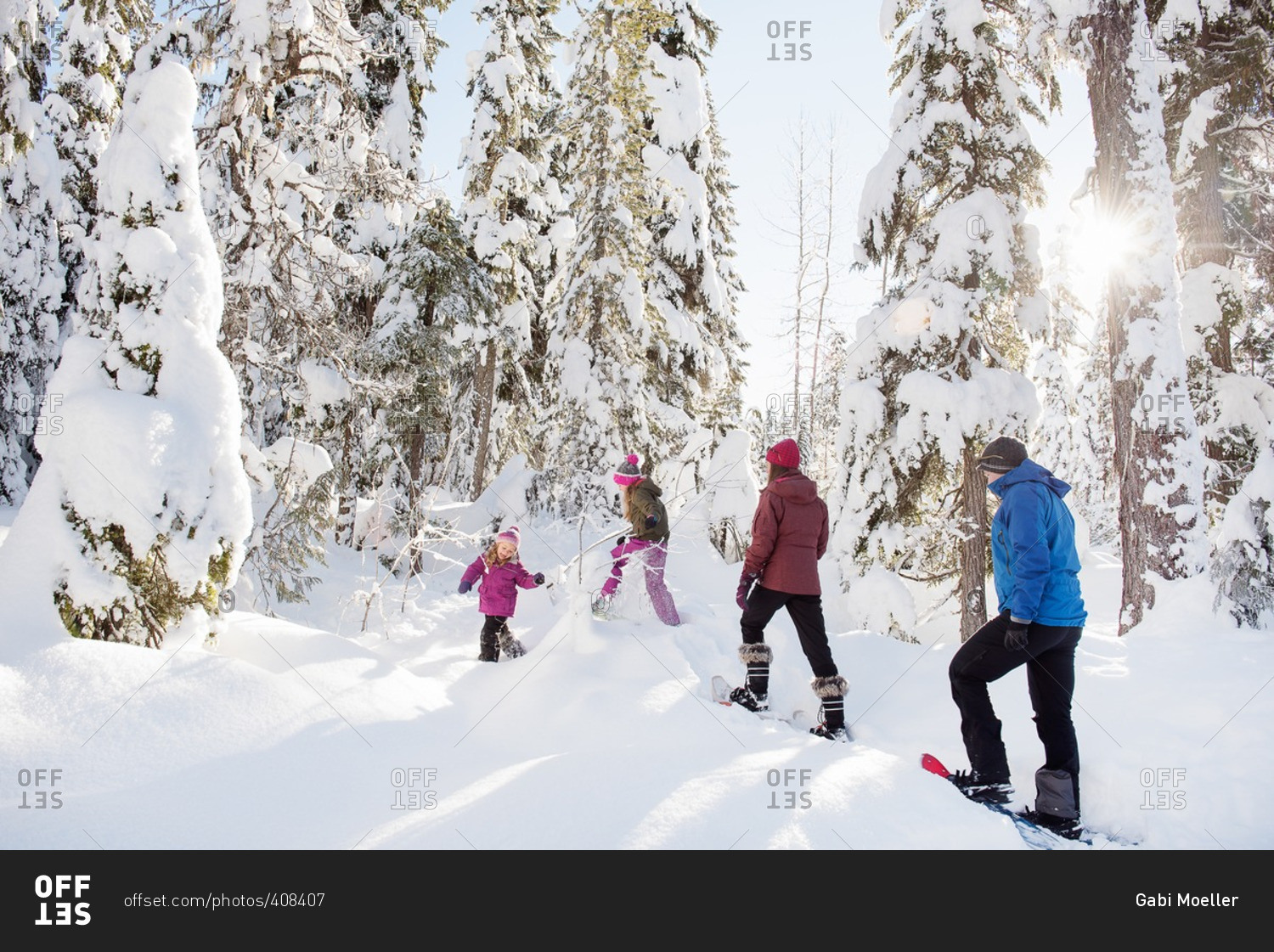 Family walking up snowy mountain