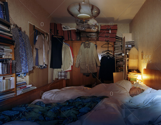 August 9, 2004: Man sleeping in a cramped apartment bedroom