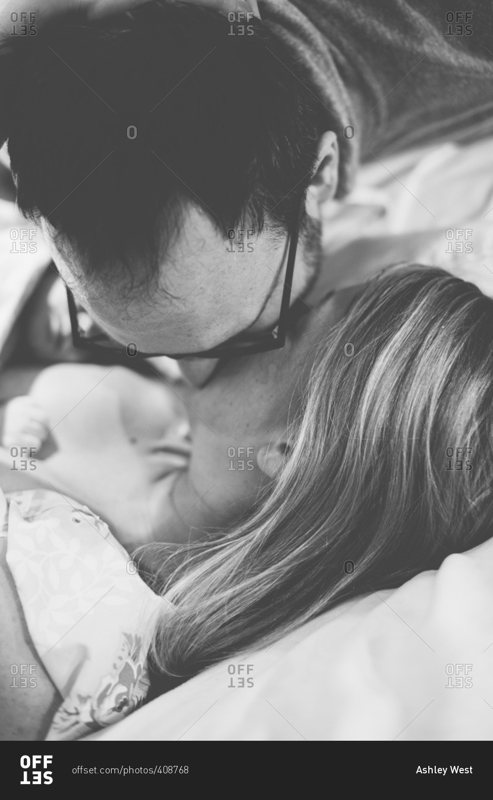 Man kisses his partner after the birth of their baby