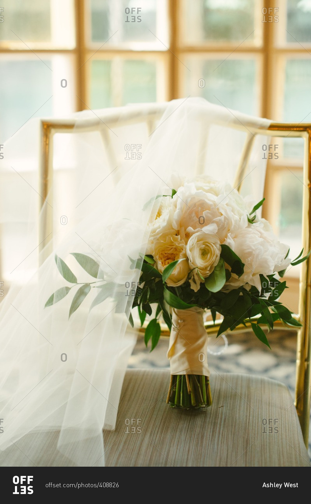 Wedding bouquet on chair with bridal veil