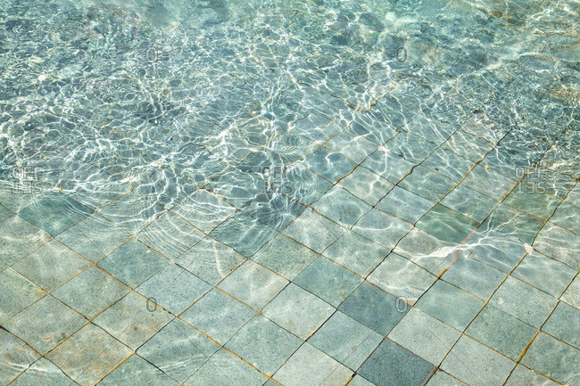 Rippled water in a blue tiled pool