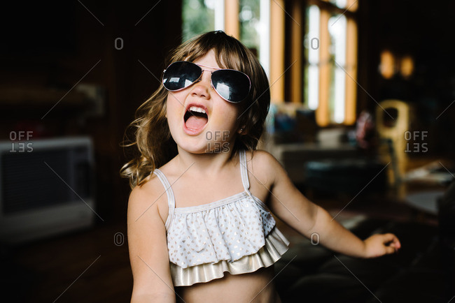 Little girl wearing aviator sunglasses stock photo - OFFSET
