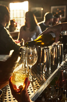 A bartender pouring a drink at a bar