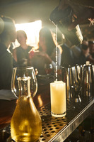 A bartender pouring a cocktail at a bar