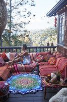 A woman relaxing on a porch in the mountains