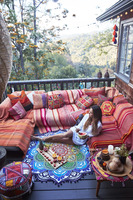 Woman eating fruit on a porch in the mountains