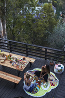 Woman eating on a porch in the mountains