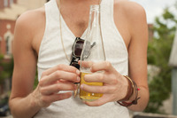 Man enjoys a beer at a party.