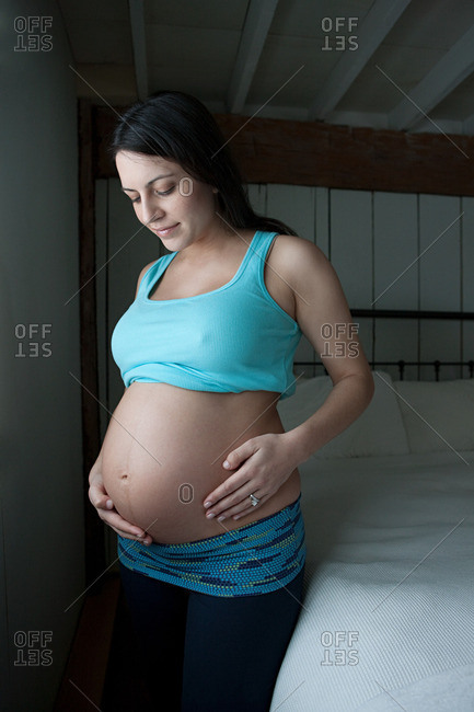 Woman showing pregnancy bump - Offset