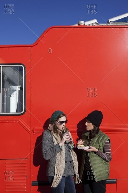Women standing next to food van