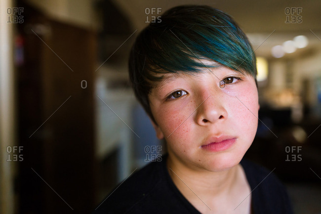 Portrait of a person with dyed blue bangs